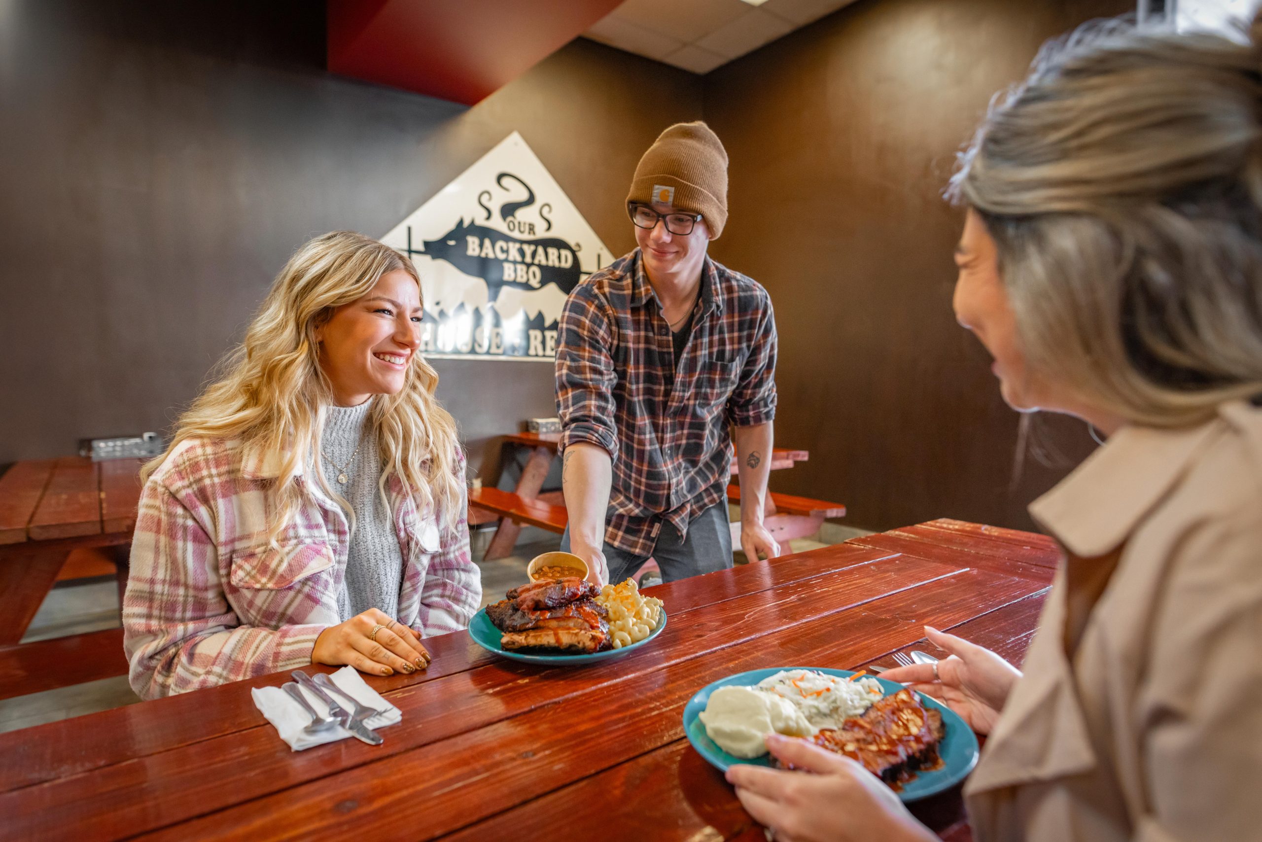 Two women eating at Backyard BBQ in Amherst, Nova Scotia
